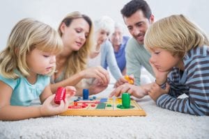 family playing a board game in the living room