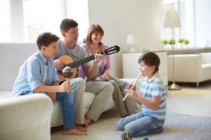 a family playing instruments and singing together in the livingroom