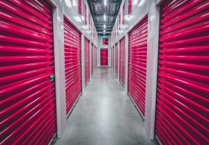 red storage doors in a long row of rooms.
